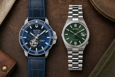 Bulova Marine Star azul e Citizen Tsuyosa verde lado a lado sobre madeira escura
