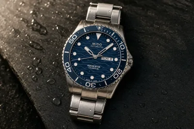 Mido Ocean Star de mostrador azul e bisel de cerâmica sobre pedra escura molhada