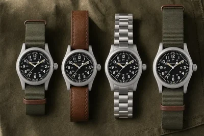Quatro versões do Hamilton Khaki Field alinhadas sobre lona oliva