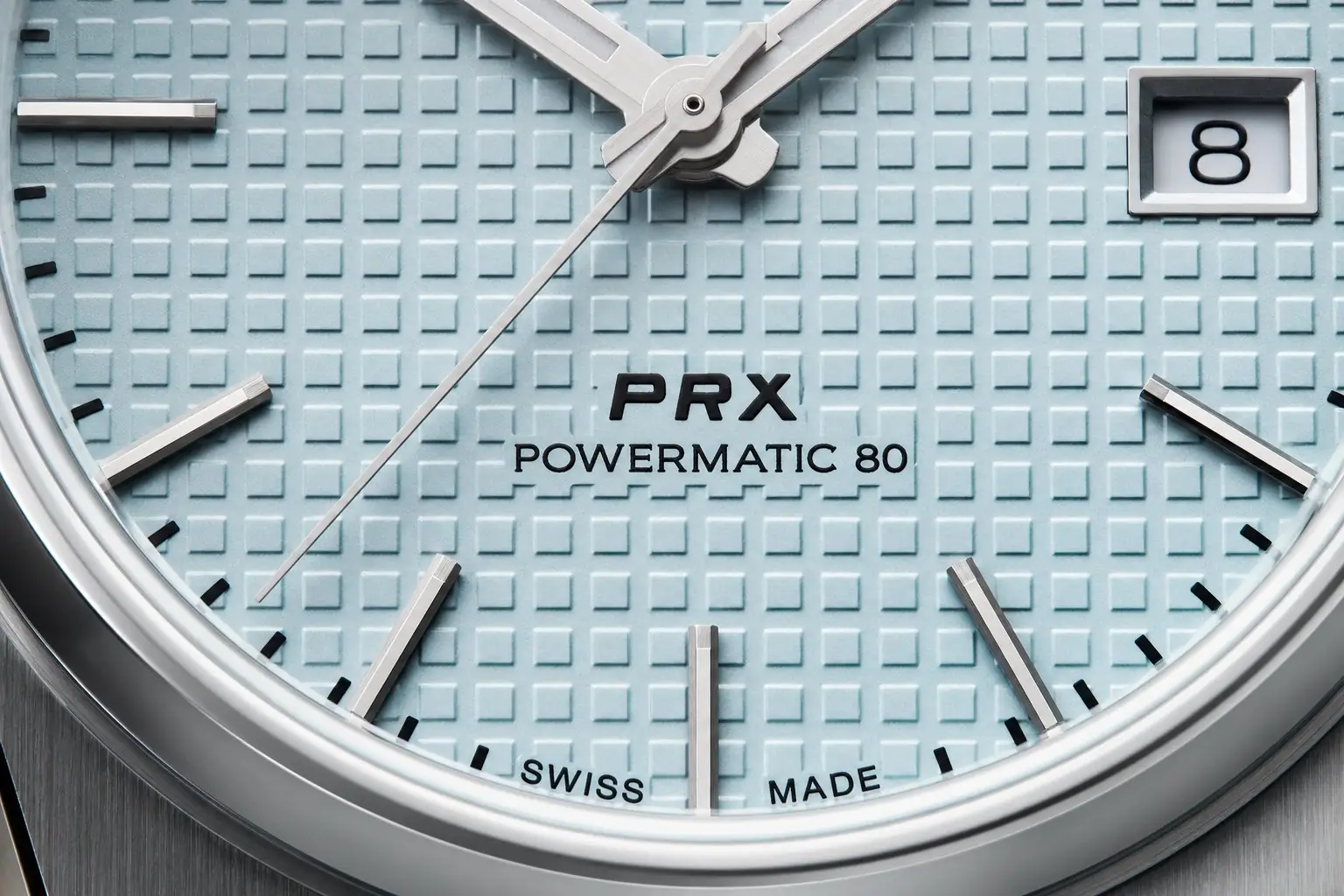 Duas linhas embaixo do centro: PRX e POWERMATIC 80. Impressão fina e alinhada com o eixo dos ponteiros.